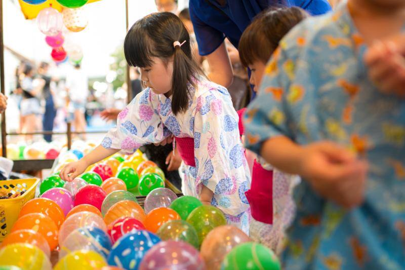 ヨーヨー釣りをする浴衣の女の子